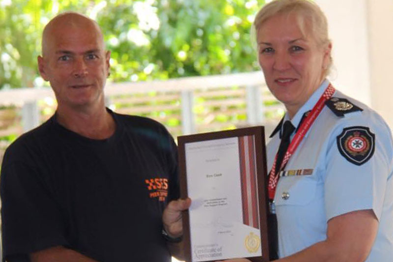Ken receives a certificate from then Commissioner of Queensland Fire and Emergency Services, Katarina Carroll APM 