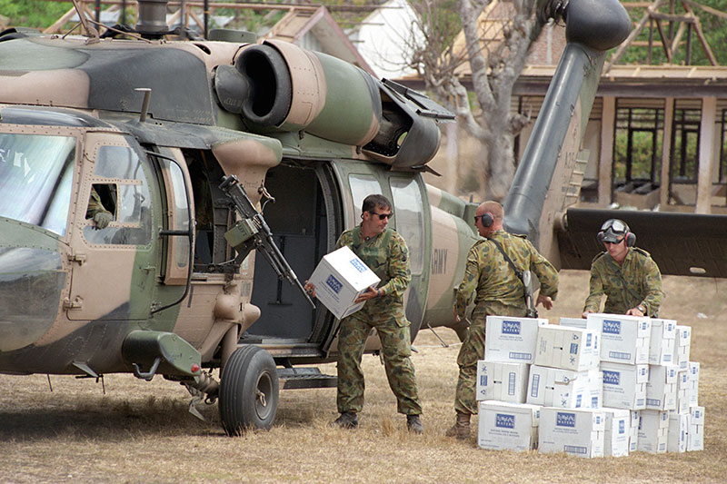 Image: Defence Australia | Australian soldiers unload fresh water from an Army Blackhawk Helicopter.