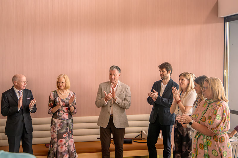 Her Excellency the Honourable Dr Jeannette Young AC PSM and other individuals applauding. 