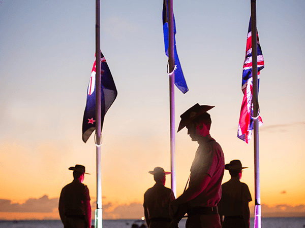 Soldiers standing with their heads bowed during a minute of silence on ANZAC Day